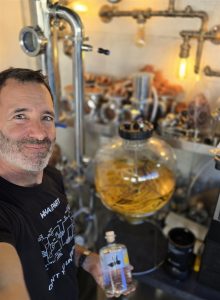Joe, the distiller, beside the still at The Law Artisan Distillery