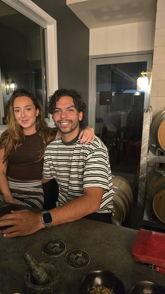 Chloe and Pablo behind the bar at The Law Artisan Distillery cellar door